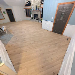 Empty room with new hardwood flooring installation in progress