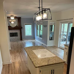 Modern kitchen with granite countertop island, stainless steel appliances, and open floor plan