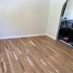 Empty room with laminate wood flooring and white walls