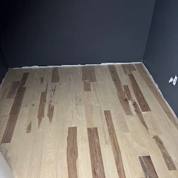 Hardwood floor with mixed wood tones and varied plank lengths in diagonal pattern
