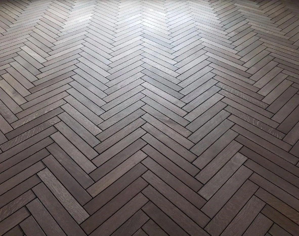 Herringbone pattern wooden floor with light and dark wood tones