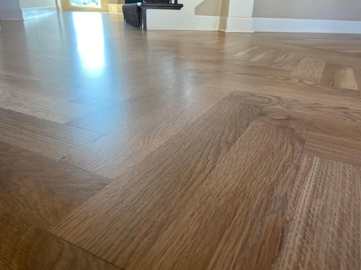 Spacious interior room with polished wood flooring and white walls